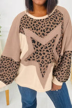 A cozy oversized round neck sweatshirt with a bold tan and beige leopard print star and solid patchwork panels