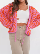 Vibrant leopard print tie-front cardigan in pink-orange fuzzy texture
