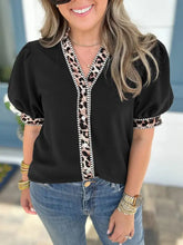 Black puff sleeve blouse with leopard trim puff along neckline front placket and cuffs in lightweight fabric
