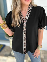 Black puff sleeve blouse with leopard trim puff sleeves and elegant leopard print detailing on cuffs and neckline