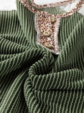 A green corduroy leopard trim raglan sleeve top with vertical stripes and a leopard-print collar accented by buttons