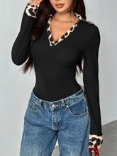 Black ribbed knit bodysuit with leopard trim ribbed neckline and cuffs featuring a trim ribbed knit texture