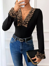 Black long sleeve bodysuit with leopard trim faux fur at the neckline and cuffs featuring a trim v neck design