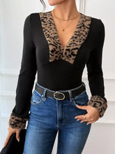 Black long sleeve bodysuit with leopard trim v neck and faux fur cuffs for stylish and elegant wear