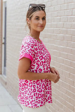 Women’s pink leopard print round neck tee with short sleeves and solid trim