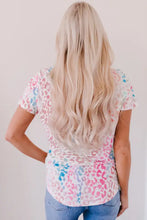 Blonde woman in leopard V-neck short sleeve tee shirt and jeans