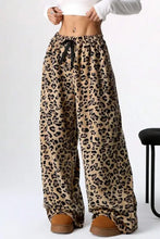 Leopard wide leg pants with drawstring waist and brown leather boots