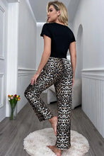 Leopard-print tapered high-waisted cropped pants paired with a lettuce trim cropped t-shirt with short sleeve length