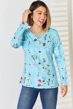 Woman in light blue crisscross printed long sleeve floral top and jeans