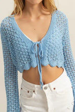Light blue crochet cropped cardigan with high-waisted white shorts