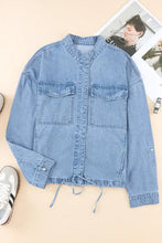 Light blue denim jacket with drawstring hem, patch pockets, distressed and lace-up details