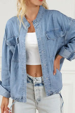 Light blue denim jacket with distressed and lace-up details
