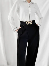 White silk blouse with black piping and geometric buckle elastic wide belt