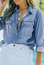 Light blue denim shirt with button-down front and chest pockets