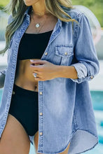 Light blue denim shirt with button-down front and chest pockets