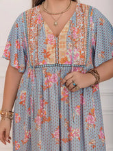 Plus size printed flutter sleeve maxi dress with floral tie neck