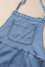 Light blue square neck denim overalls with front pocket and cuffed hems