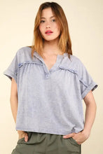 Light blue washed knit fabric top with notched short sleeve ruffles