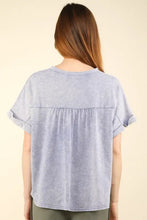 Light blue washed knit fabric top with notched short sleeve