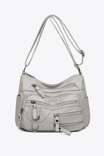 Light gray multi-pocket PU leather crossbody bag with adjustable strap