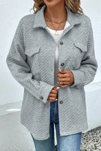 Light gray quilted jacket with long sleeve length and button closure