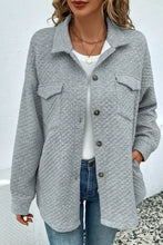 Light gray quilted jacket with long sleeve length and button closure