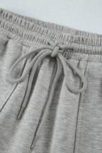 Light gray wide-leg drawstring active pants with cargo pockets