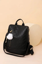 Black quilted zipper backpack with pom-pom detail and adjustable straps