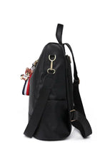 Light gray zipper backpack with black leather and patriotic tassel charm