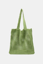 Light green openwork tote bag with perforated design and shoulder strap