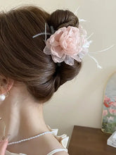Light pink feather trim flower hair claw clip with bun styling