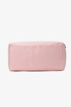 Blush pink nylon crossbody bag with zipper toiletry closure