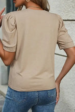 Light tan round neck puff sleeve casual t-shirt with blue jeans