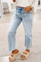 Light wash utility pocket straight leg jeans in denim with frayed hems and a straight-leg cut