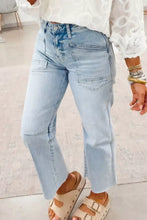 Light wash utility pocket straight leg jeans with high-rise fit and frayed hems in light wash denim