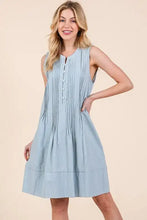 Light blue sleeveless midi dress with denim pintuck detail, button-front neckline, and tiered hem by Lime N Chili