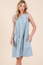Light blue sleeveless midi dress with vertical denim pintuck pleats and button front neckline by lime n chili