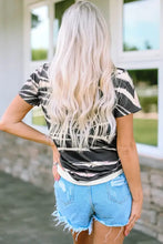Woman in graphic round neck short sleeve tie-dye t-shirt and denim shorts