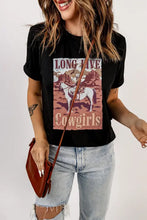 Black long live cowgirls graphic tee with distressed jeans and brown bag