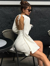 Back view of white Long Sleeve Backless Sweater Dress with back tie and ruffled hem