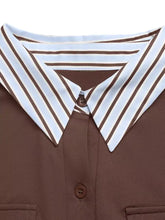 Long sleeve button front bodysuit with brown and white striped collar on a brown button up shirt fabric