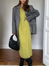 Black leather hobo bag with minimalist design on knit dress
