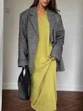 Woman in gray herringbone blazer over lime green Long Sleeve Collared Neck Knit Dress