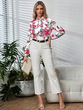Long sleeve floral blouse with tie neck on white background