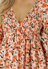 Peach long sleeve floral print mini dress with ruffled neckline