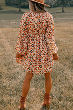 Long sleeve floral print mini dress with tie waist on orange background