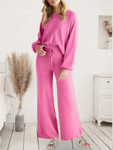A vibrant pink long sleeve lounge top and wide-leg drawstring pants set with loose fitting sleeve length for comfort