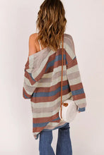 Long sleeve striped knit cardigan in brown, white, and black with oversized sleeves
