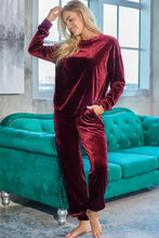 A plush burgundy velvet long sleeve top and pants lounge set with tapered pants and a natural waistline