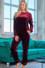 A plush deep burgundy velvet long sleeve top and tapered pants lounge set with sleeve length detail and natural waistline
